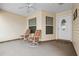 Relaxing front porch with two chairs, perfect for enjoying the outdoors with a ceiling fan at 3341 Highland Fairways Blvd, Lakeland, FL 33810