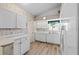 Clean kitchen with white cabinets, appliances, and luxury vinyl plank flooring at 3341 Highland Fairways Blvd, Lakeland, FL 33810