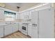 Well-lit kitchen features white cabinets and appliances at 3341 Highland Fairways Blvd, Lakeland, FL 33810