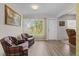 Bright living room features hardwood floors, natural light and comfortable plaid armchairs at 3341 Highland Fairways Blvd, Lakeland, FL 33810