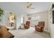 Comfortable living area with cozy leather chairs, natural lighting, and neutral carpet at 3341 Highland Fairways Blvd, Lakeland, FL 33810