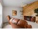Inviting living space with a leather recliner, a cozy fireplace, and unique wall decor at 3341 Highland Fairways Blvd, Lakeland, FL 33810