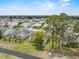 An overhead view of the property showing the cozy home and surrounding neighborhood with mature trees at 3341 Highland Fairways Blvd, Lakeland, FL 33810