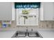 Well-maintained kitchen sink features a modern faucet and backyard view at 3341 Highland Fairways Blvd, Lakeland, FL 33810