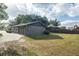 Large backyard with mature trees and a detached garage for additional storage at 4008 S Carlisle Rd, Lakeland, FL 33813