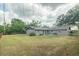 Large backyard with green grass, trees, and privacy, perfect for outdoor activities and relaxation at 4008 S Carlisle Rd, Lakeland, FL 33813