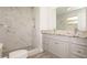 Renovated bathroom features double sinks, a tiled walk-in shower, and stylish vanity lights at 4008 S Carlisle Rd, Lakeland, FL 33813