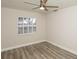 Bright bedroom with wood floors, a ceiling fan and a window with plantation shutters at 4008 S Carlisle Rd, Lakeland, FL 33813