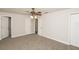 Bright bedroom featuring a ceiling fan, neutral carpet, and closet for storage at 4008 S Carlisle Rd, Lakeland, FL 33813