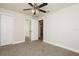 Bedroom features a ceiling fan, a mirrored closet, carpet, and neutral paint color at 4008 S Carlisle Rd, Lakeland, FL 33813