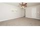 Bedroom features a ceiling fan, window for natural light, carpet, and neutral paint color at 4008 S Carlisle Rd, Lakeland, FL 33813