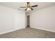 Bright bedroom with neutral carpet, a ceiling fan, and closet space at 4008 S Carlisle Rd, Lakeland, FL 33813