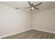 Light and airy bedroom featuring wood-look flooring and a modern ceiling fan at 4008 S Carlisle Rd, Lakeland, FL 33813