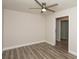 Cozy bedroom featuring wood-look floors, a ceiling fan, and closet for ample storage at 4008 S Carlisle Rd, Lakeland, FL 33813