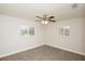 Carpeted bedroom features two windows with plantation shutters and a modern ceiling fan at 4008 S Carlisle Rd, Lakeland, FL 33813