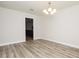 Bright dining room with wood-look floors, a modern chandelier and an open floor plan at 4008 S Carlisle Rd, Lakeland, FL 33813