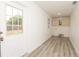 Bright laundry room features hardwood floors, a utility sink, a window, and plenty of cabinet space at 4008 S Carlisle Rd, Lakeland, FL 33813
