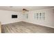 Open living room with wood-look floors, plantation shutters, and modern features at 4008 S Carlisle Rd, Lakeland, FL 33813