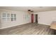 Spacious living room with wood-look floors, plenty of natural light, and neutral paint colors at 4008 S Carlisle Rd, Lakeland, FL 33813