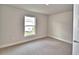 Bedroom with plush carpeting, natural light, and a view of the backyard at 4023 Tullamore Ln, Auburndale, FL 33823