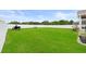 Expansive backyard with well-maintained lawn, white fence, and a verdant landscape at 4041 Byrds Crossing Dr, Lakeland, FL 33812