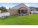 Expansive backyard featuring a screened patio and well-maintained lawn, great for outdoor living at 4041 Byrds Crossing Dr, Lakeland, FL 33812