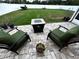 A brick patio with a firepit and cushioned seating overlooks the grassy, fenced backyard at 4041 Byrds Crossing Dr, Lakeland, FL 33812