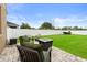 Lush backyard featuring a patio with green seating and view of the lawn at 4041 Byrds Crossing Dr, Lakeland, FL 33812