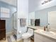 Well-lit bathroom featuring a walk-in shower, toilet, vanity, and soft blue walls at 4041 Byrds Crossing Dr, Lakeland, FL 33812