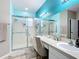 Bright bathroom features a double vanity, mirrors, and a walk-in shower at 4041 Byrds Crossing Dr, Lakeland, FL 33812