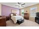 Cozy bedroom with neutral carpet, ceiling fan, and two windows at 4041 Byrds Crossing Dr, Lakeland, FL 33812
