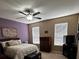 Relaxing bedroom with purple accent wall, a double bed, and a ceiling fan at 4041 Byrds Crossing Dr, Lakeland, FL 33812