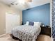 Comfortable bedroom featuring a ceiling fan, closet, and stylish blue accent wall at 4041 Byrds Crossing Dr, Lakeland, FL 33812