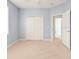 This bedroom has neutral carpet, pale blue walls and white trim, and a large closet at 4041 Byrds Crossing Dr, Lakeland, FL 33812