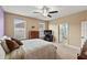 This bedroom offers a ceiling fan, two windows and an electric fireplace at 4041 Byrds Crossing Dr, Lakeland, FL 33812