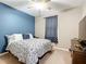 Comfortable bedroom features a ceiling fan, and patterned curtains with a decorative bed at 4041 Byrds Crossing Dr, Lakeland, FL 33812
