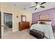 This bedroom is equipped with a ceiling fan, a dresser and a leather bench at 4041 Byrds Crossing Dr, Lakeland, FL 33812