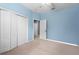 This light blue bedroom features a window, closet and access to another room at 4041 Byrds Crossing Dr, Lakeland, FL 33812