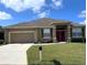 Charming one-story home boasts a well-manicured lawn and a two-car garage at 4041 Byrds Crossing Dr, Lakeland, FL 33812
