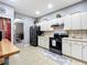 Well-lit kitchen features tiled flooring, stainless steel refrigerator, and light countertops at 4041 Byrds Crossing Dr, Lakeland, FL 33812