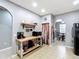 Open kitchen layout with rustic wooden shelving and modern stainless steel appliances at 4041 Byrds Crossing Dr, Lakeland, FL 33812