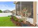 Charming side yard with lush landscaping and a view of the screened-in porch at 4041 Byrds Crossing Dr, Lakeland, FL 33812