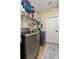 A convenient laundry room featuring modern washer and dryer units and shelving at 4041 Byrds Crossing Dr, Lakeland, FL 33812