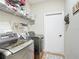 Functional laundry room equipped with modern washer and dryer and ample storage shelving at 4041 Byrds Crossing Dr, Lakeland, FL 33812