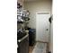 Well-equipped laundry room features washer, dryer, storage shelving and tile flooring at 4041 Byrds Crossing Dr, Lakeland, FL 33812