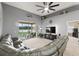 Spacious living room boasts vaulted ceiling, ceiling fan, and sliding glass doors to lanai at 4041 Byrds Crossing Dr, Lakeland, FL 33812