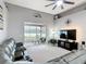 Open-concept living room features high ceilings, a ceiling fan, and a screened-in patio at 4041 Byrds Crossing Dr, Lakeland, FL 33812