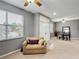This inviting living room boasts plush seating, neutral tones, and natural light, seamlessly connecting to the dining area at 4041 Byrds Crossing Dr, Lakeland, FL 33812
