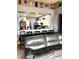 Open concept living space with bar seating and a gray leather sectional sofa at 4041 Byrds Crossing Dr, Lakeland, FL 33812