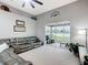 Open-concept living room features high ceilings, a ceiling fan, and a screened-in patio at 4041 Byrds Crossing Dr, Lakeland, FL 33812